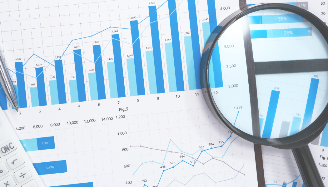 data charts with magnifying glass